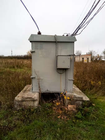 Transformer booth with wires and concrete pillars near it