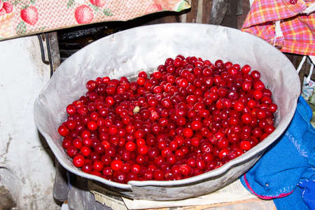 Fresh cherries in an aluminum large bowlの写真素材