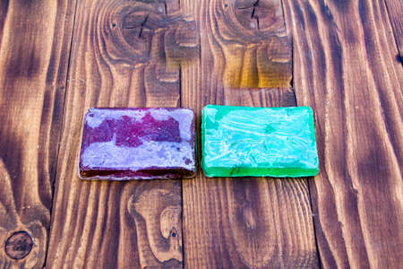 Purple and green toilet soap on dark backgroundの写真素材