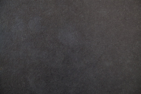 Clean black surface smooth background with white grains, blackboard or table textureの写真素材
