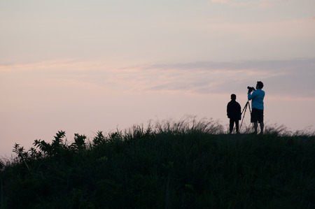 silhouette with man and boy for take a photoの写真素材