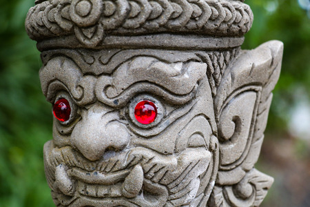 Thai stone ancient statue with ruby gem eyes in, Thailandの写真素材