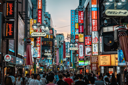 TOKYO, JAPAN - AUGUST 5, 2018: View of Shibuya shopping street with thousands of people and neon signs during sunsetのeditorial素材