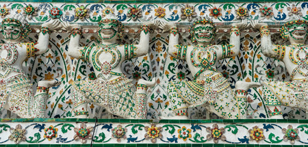 Closeup shot of historic colorful murals in Wat Arun temple depicting Thai warriors, Bangkok, Thailandの写真素材