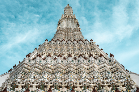 Closeup shot of stone warrior statues of Wat Arun temple during bright sunny day with blue sky, Bangkok Thailandの写真素材