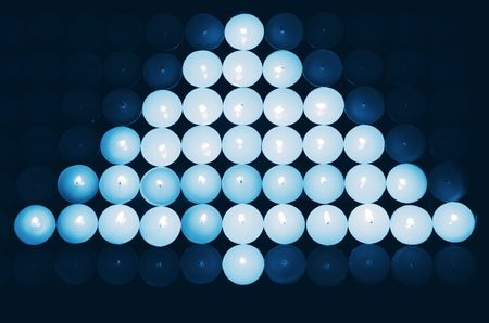 Blue Christmas tree made of small candlesの写真素材