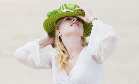 Girl posing in green hat - high-keyの写真素材