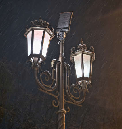 street lamp at night in winter during heavy snow close up