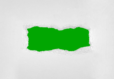 frame of torn white paper on green background close upの写真素材