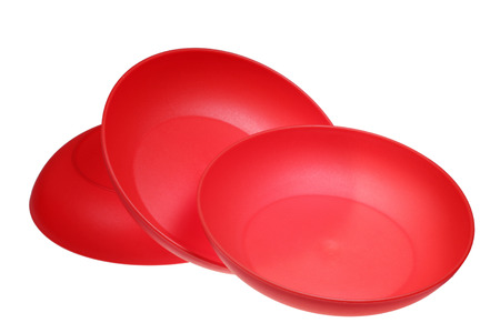 Plastic red piattis are isolated on a white backgroundの写真素材