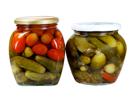 Tinned vegetables - cucumbers, tomatoes in a glass jar it is isolated on a white backgroundの写真素材