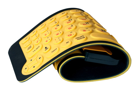 The yellow flexible computer keyboard it is isolated on a white backgroundの写真素材