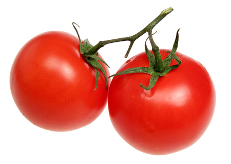 Ripe tomatoes it is isolated on a white backgroundの写真素材