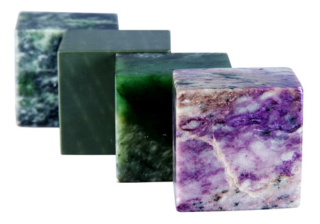 The cube from a mineral also charoit nephrite is isolated on a white background