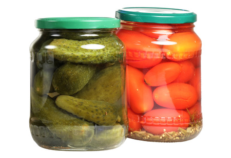 Canned tomatoes and cucumbers in a can it is isolated on a white backgroundの写真素材