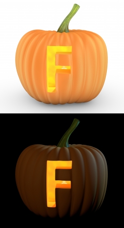 F letter carved on pumpkin jack lantern isolated on and white backgroundの写真素材