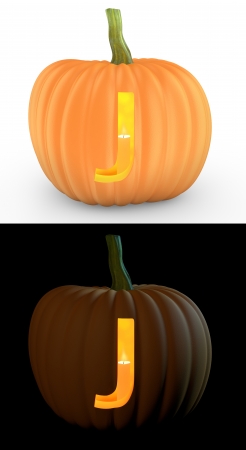 J letter carved on pumpkin jack lantern isolated on and white backgroundの写真素材