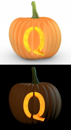 Q letter carved on pumpkin jack lantern isolated on and white backgroundの写真素材