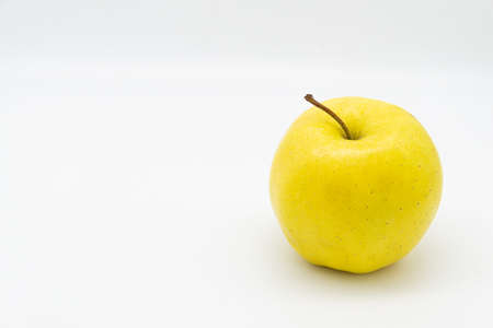 ripe tasty yellow golden apple isolated on white background. copy space for textの写真素材