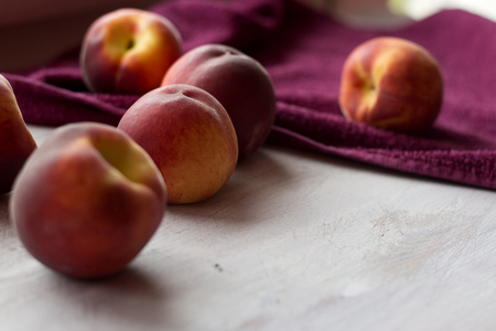 Sweet red peaches on white wooden backgroundの写真素材