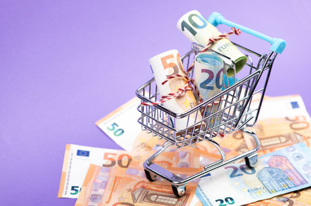 Shopping cart full of roll euro banknotes.の写真素材
