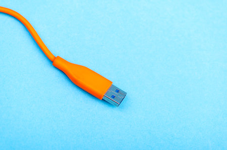 USB Cable Plug isolated on Blue Backgroundの写真素材