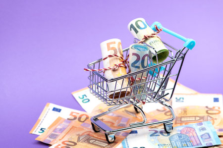Shopping cart full of roll euro banknotes.の写真素材