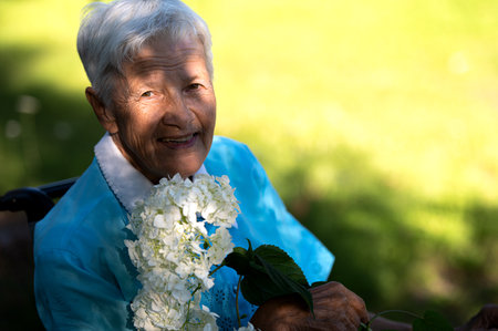Rear view on disabled old woman in a wheelchair on the highwayの写真素材