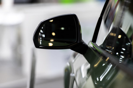 Side rear-view mirror on a modern car on blurred traffic backgroundの写真素材
