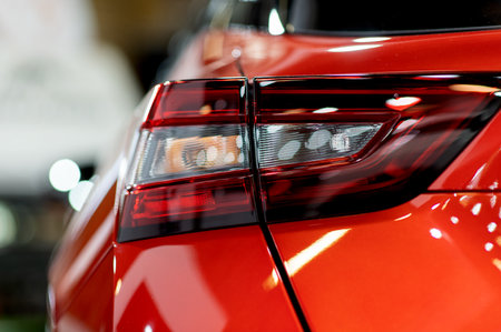 Tail light of nice and new orange sport suv car in modern garage.の素材 [FY310193322881]