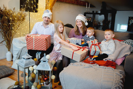 Happy family with three children celebration Christmas on decorated background at home.Happy childhood, parenthood, happy holiday and family concept.の写真素材