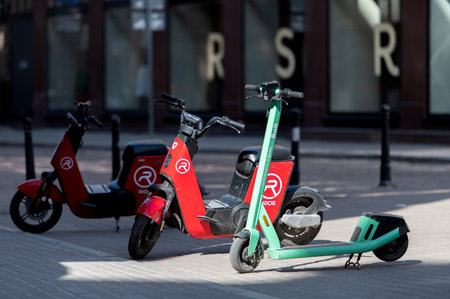 Riga, Latvia - April 02, 2022: Bolt and Ride electric rental scooters are parked on a sidewalk in...