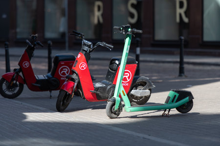 Riga, Latvia - April 02, 2022: Bolt and Ride electric rental scooters are parked on a sidewalk in Riga old cityのeditorial素材