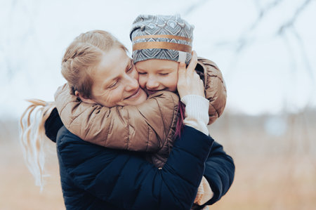 Loving mom and her little daughter embrace each other in a moment of love emotionの写真素材