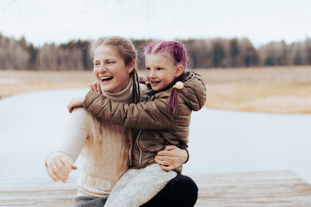 Happy mother and daughter at the lake