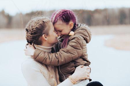 Loving mom and her little daughter embrace each other in a moment of love emotionの写真素材