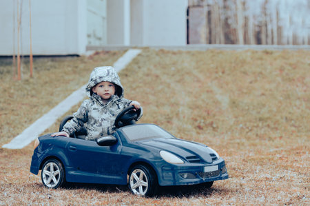 Baby boy kid close up portrait with toy car outdoors.の写真素材