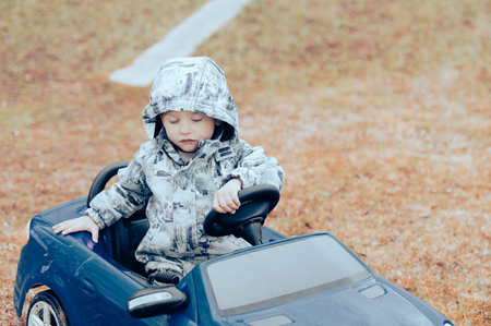 Baby boy kid close up portrait with toy car outdoors.の写真素材