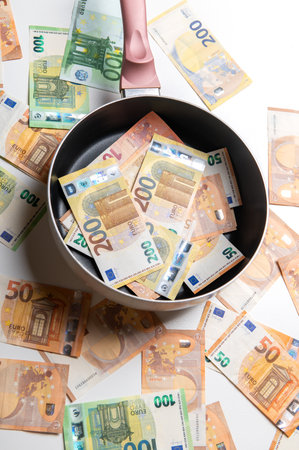 New frying pan with money euro banknotes on a white background.の写真素材