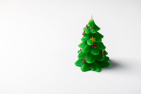 Christmas tree green decorative candle isolated on white backgroundの写真素材