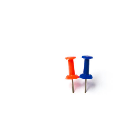 two different colorful push pins isolated on white background