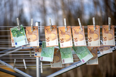 100 and 50 euro banknotes drying. Washed Euro paper bills. Drying euro on a string.Money launderingの写真素材