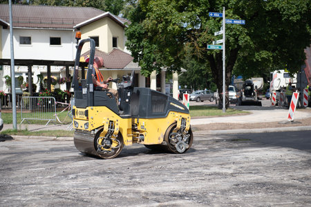 August 4, 2021: Construction site is laying new asphalt road pavement,road construction workers and road construction machinery scene in Sigulda,Latviaのeditorial素材