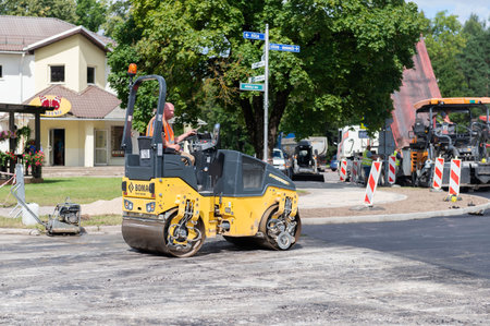 August 4, 2021: Construction site is laying new asphalt road pavement,road construction workers and...