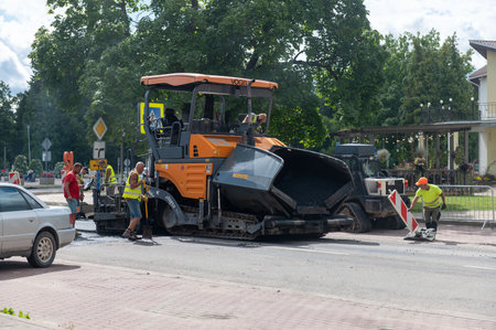 August 4, 2021: Construction site is laying new asphalt road pavement,road construction workers and...