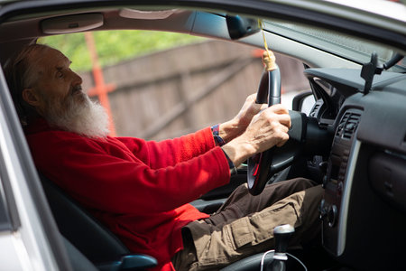 Retired elder senior  man with long beard driving carの写真素材