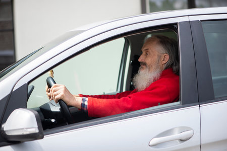 Retired elder senior  man with long beard driving gray car