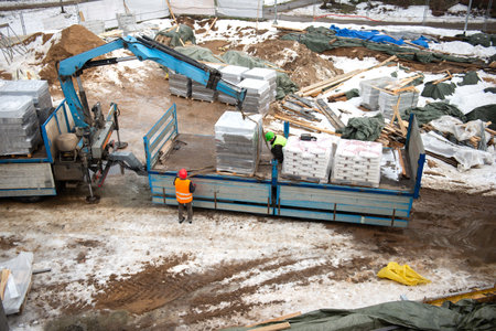 Delivery and unloading from truck of aerated concrete blocks building material at the construction...