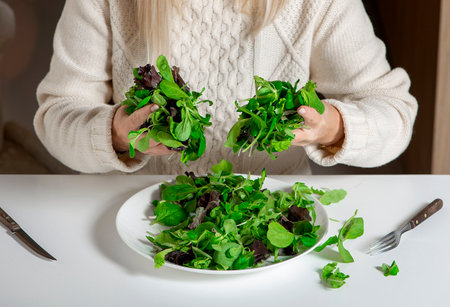 Close-up of woaman hands holding green lettuce leaves,healthy liefestyle,diet and food concept