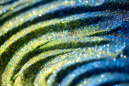 Shiny yellow green blue turquoise glitter textured blurred backgroundの写真素材